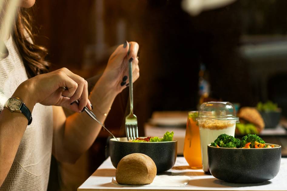 Fresh healthy meal delivery containers on wooden table